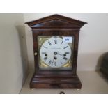 A mahogany cased mantle clock by Mapping and Webb, white enamel dial with Roman numerals,