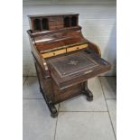 A Victorian Walnut Piano top Davenport with a rising correspondance top and side door enclosing 4 x