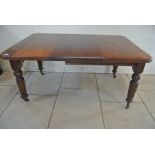 A 19th Century mahogany wind-out dining table with one leaf on turned reeded legs - 73cm tall x