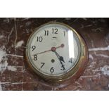 A brass Military bulkhead clock by Elliott no 0552/724 on a mahogany mount with 6 inch dial -