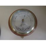 An oak cased aneroid bulkhead barometer by Dolland of London - 17cm diameter