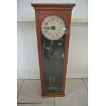 An oak cased National Electric master clock - 134cm tall x 42cm x 23cm - was working in vendors