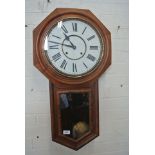 An American eight day wall clock drop-case showing pendulum,