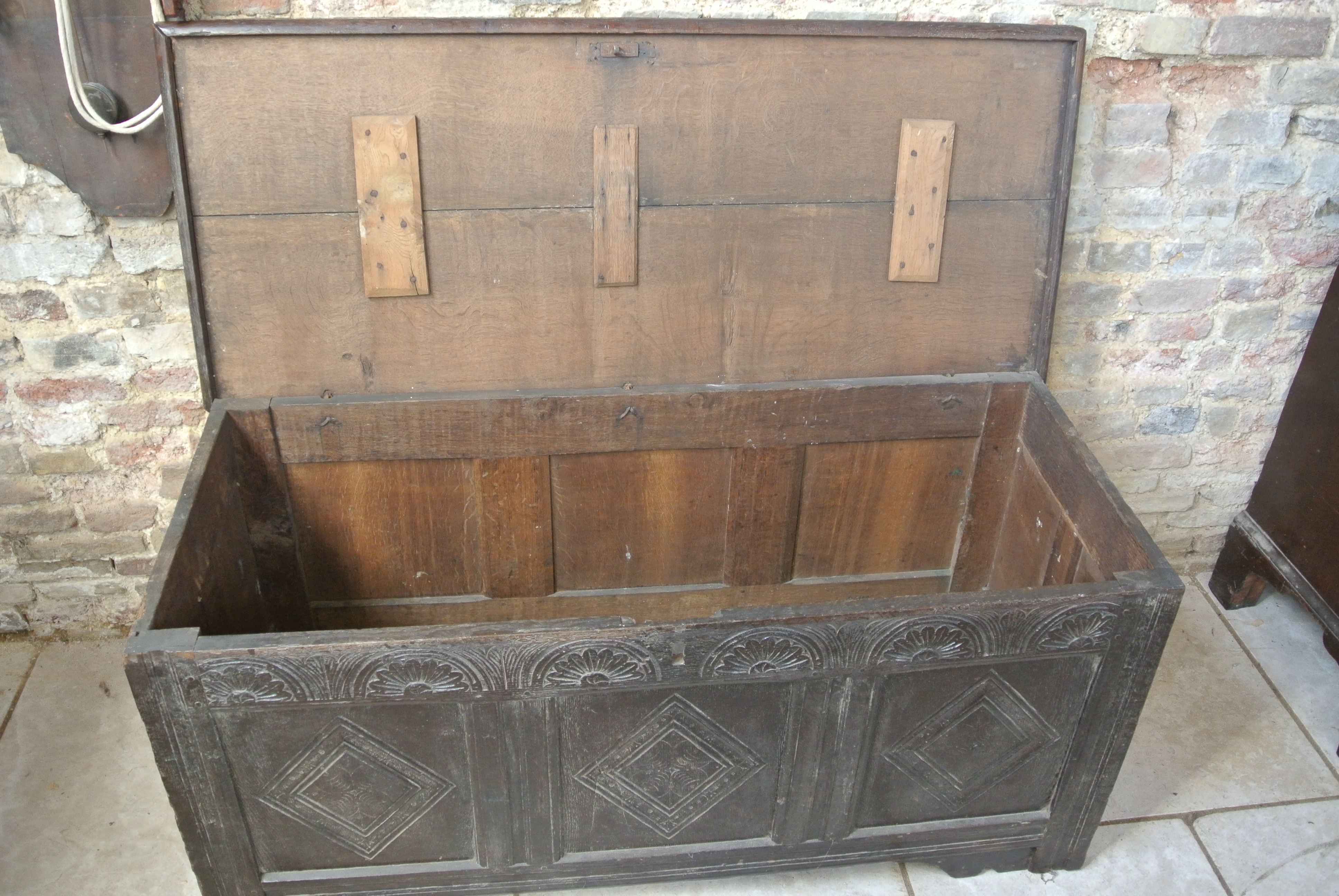 An 18th Century oak coffer with a carved front - 64cm tall x 138cm wide - some wear mainly to the - Image 2 of 2
