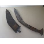 A Kukri Knife - 41cm long - some pitting and chips to blade - wear to scabbard,