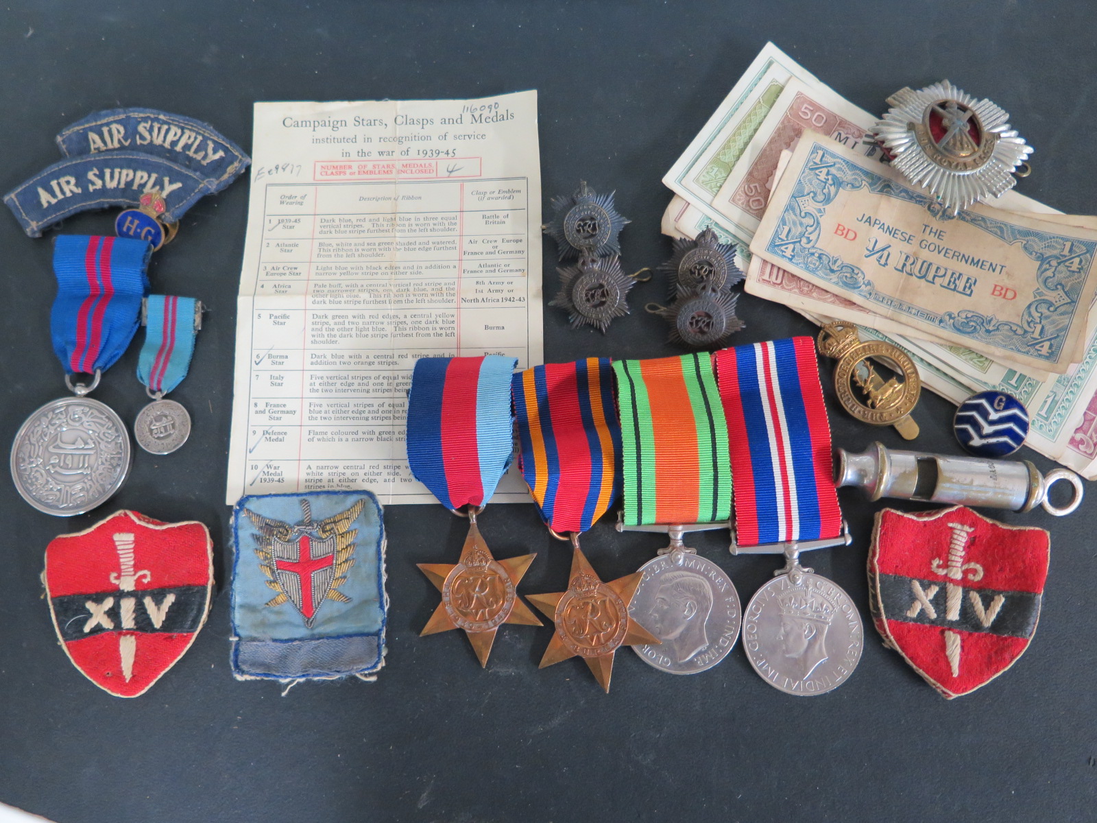 A group of four WWII medals, a George V medal with dress medal, assorted badges,