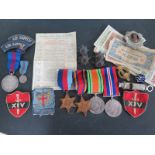 A group of four WWII medals, a George V medal with dress medal, assorted badges,