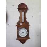 An Oak Aneroid Barometer with Thermometer - 73 cm tall