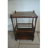 A Victorian walnut Canterbury whatnot with a base drawer - needs restoration - missing casters,