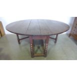A large 17th/18th century oak oval gateleg table raised on six bobbin turned legs measuring Width