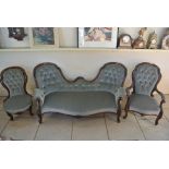 A Victorian Carved Walnut three piece suite consisting of a double ended chaise,