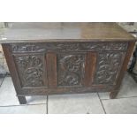 A 20th Century Carved Oak three panelled coffer - 115 cm wide x 76 cm high