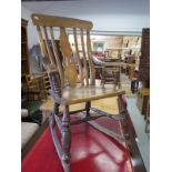 A Victorian Ash rocking chair with a shaped splat and bobbin turned supports
