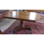 A 19th century rosewood tilt top breakfast table on a tripartite platform base,