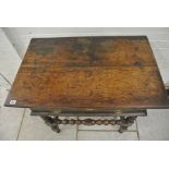 An 18th Century oak side table with a single drawer on bobbin turned supports and stretchers - 75