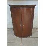 A 19th century mahogany bowfronted two door corner cupboard - Height 99cm x Width 68cm