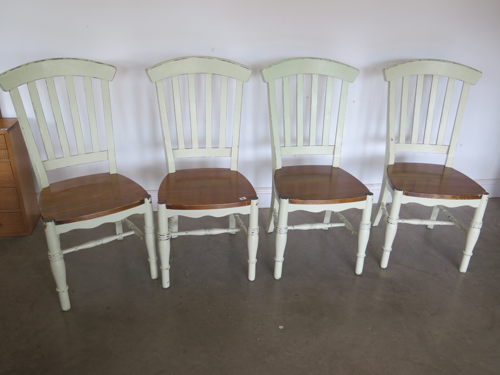 A set of four modern painted dining chairs with oak seats