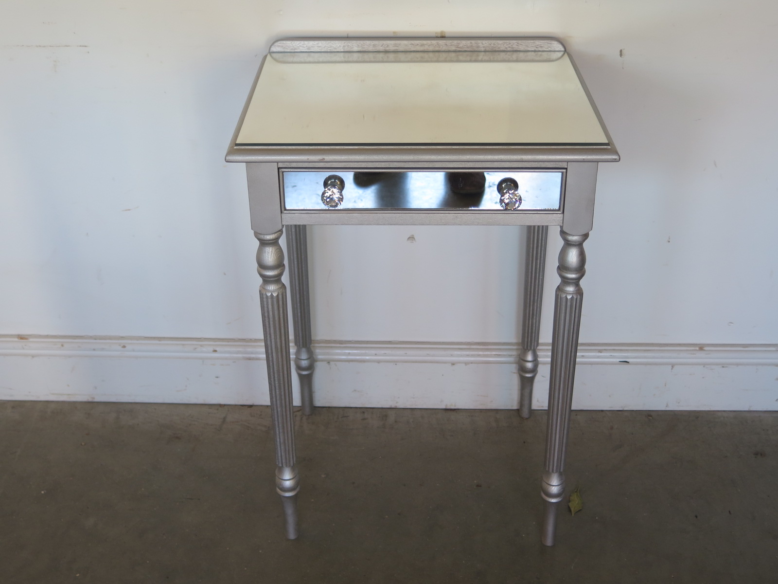 A modern silver side table with a mirrored top - Height 73cm x Width 53cm - in good condition