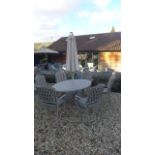 A Bramblecrest Rome elliptical table with six armchairs with cushions,