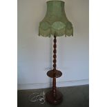 An oak standard lamp, having barley-twist column,