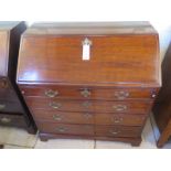 A Georgian mahogany bureau with four drawers and fitted interiors standing on bracket feet - 103cm