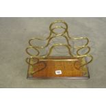 An Oaked base brass paper rack