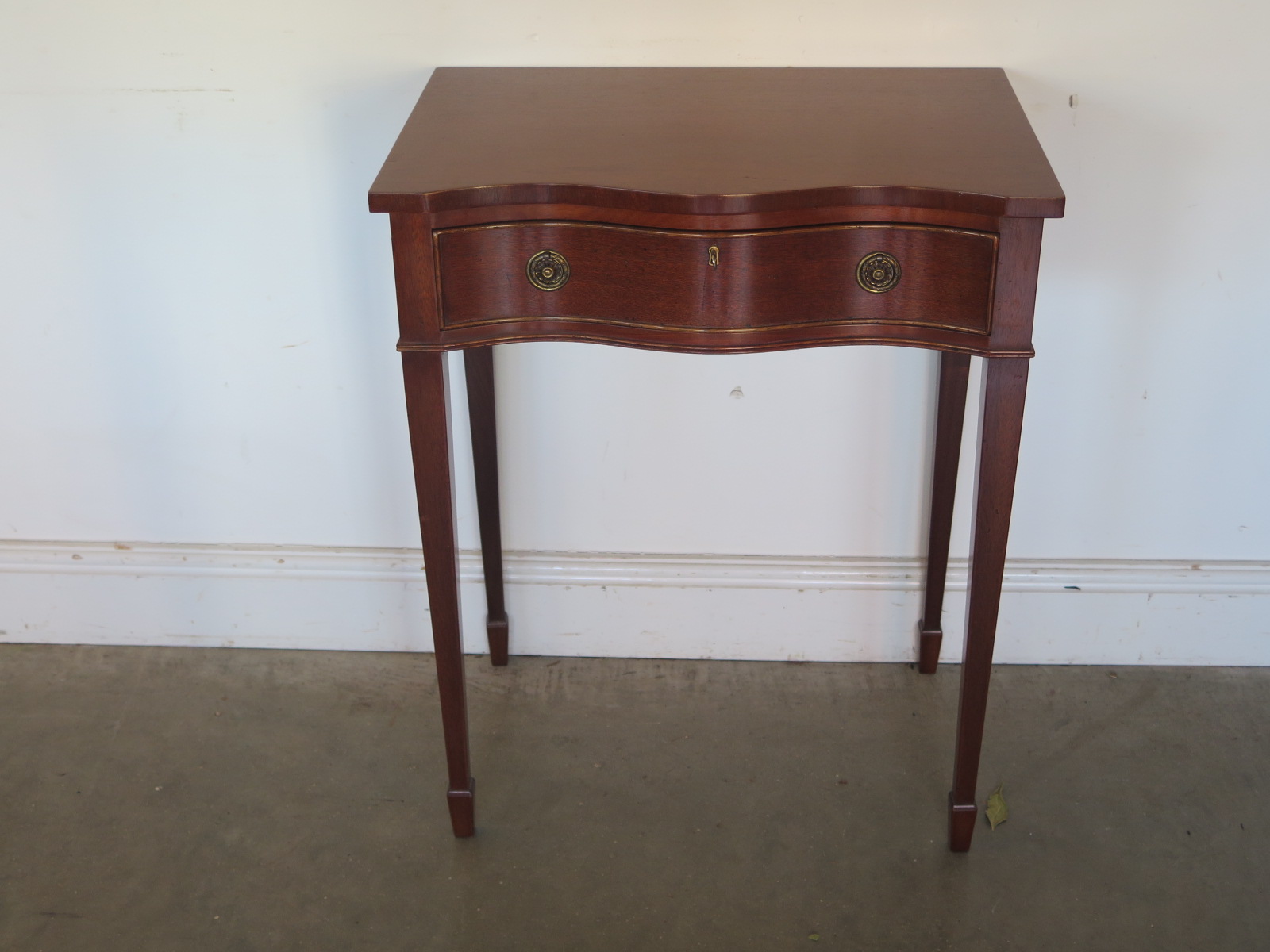 A modern side table with a serpentine front - Width 61cm x Height 77cm - in good condition