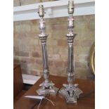 A pair of silver plated empire style table lamps on tri form bases in working order and PAT tested