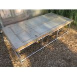 An interesting table made from a large 19th century door under a glass top and the base made from