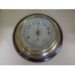 A mahogany and brass bulkhead aneroid barometer - 27cm diameter