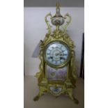 A 19th Century Gilt Mantle clock with a porcelain dial,