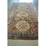 A hand knotted Persian Baluchi rug - 2.25m x 1.
