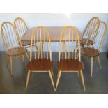 A Blonde Ercol Drop Leaf Dining Table and Six Stick Back Dining Chairs