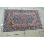 A Hand Knotted Woollen Rug with central medallion and cream field - 170 cm x 93 cm - generally good