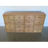 A Bank of Sixteen Oak Drawers - 121 cm x 22 cm x 63 cm high