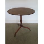 A 19th Century mahogany tilt top oval wine table on a tripod base - 71 cm tall x 61 cm x 42 cm - on