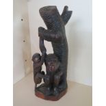 A hardwood carving of two monkeys below a tree - in good condition