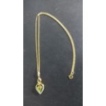 A 9ct Gold Peridot and Diamond Pendant on a 46 cm chain - pendant 3 cm long - approximately 4.