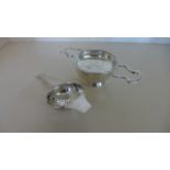 A silver strainer and cup London 1983 and another silver strainer - total silver weight approx 4.