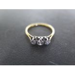 A 18ct yellow gold three stone diamond ring size N - approx weight 1.