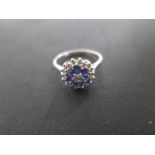An 18ct white gold diamond and sapphire cluster ring - size M/N - approximately 3.
