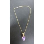 A 9ct Yellow Gold pear-shaped Amethyst Pendant on a 9ct chain - 40 cm long,