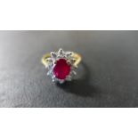An 18ct Yellow Gold Ruby and Diamond Cluster Ring - size K,