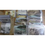 Approximately 200 assorted postcards in plastic covers