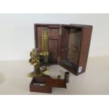 A Pillischer of London brass microscope "The International" No: 3154 with case and optics