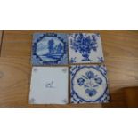 A group of four 18th Century blue and white English and Dutch Delft tiles variously decorated -