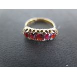 An 18ct yellow gold garnet five stone ring size M - approx weight 4.