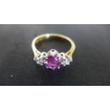 An 18ct Yellow Gold Ruby and Diamond Ring, Size P, approx 3.6 grams, the central approx 1.