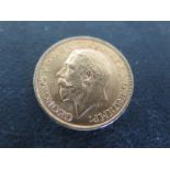 A George V full Sovereign dated 1912 - in good condition with a few dents to rim