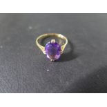 An 18ct yellow gold amethyst single stone ring size L - approx stone size 11.